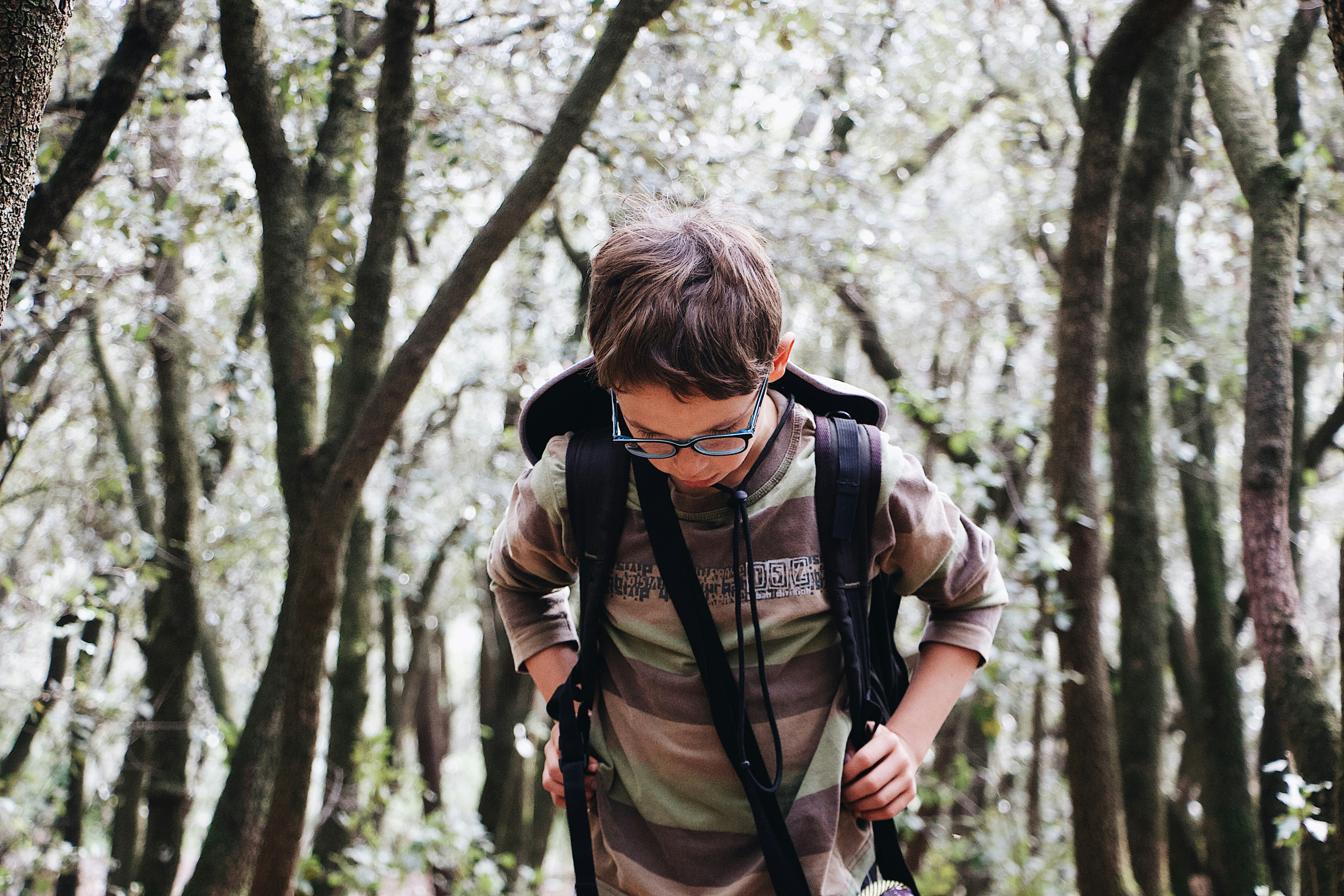 shallow focus photo of boy in brown long-sleeved shirt